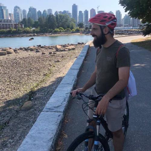 Photo of Ivan on a bike near a river